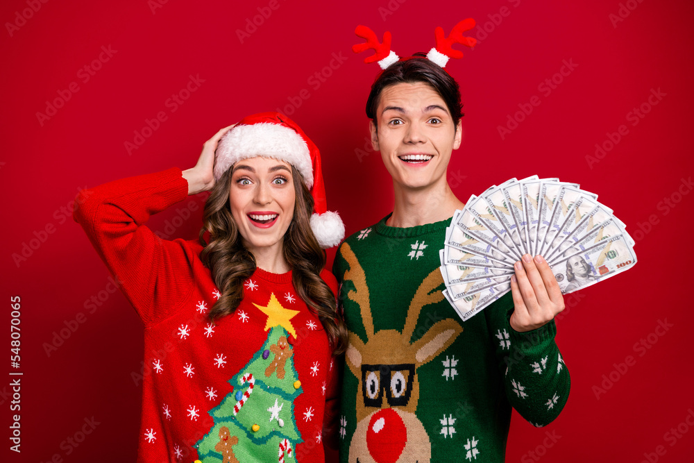 Sticker Photo of funny crazy partners hold usd dollar bills banknotes cashback profit isolated on red color background