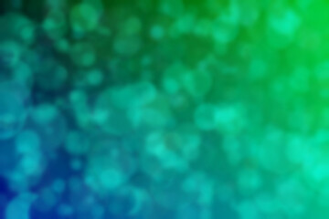 Harmonic gradient with transitions of green and blue colors and circle shaped bokeh
