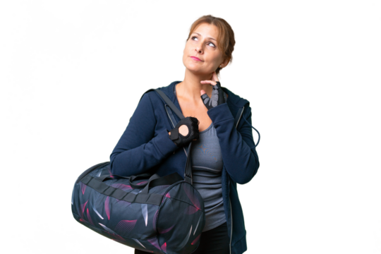 Middle-aged sport woman with sport bag over isolated background thinking an idea - Powered by Adobe