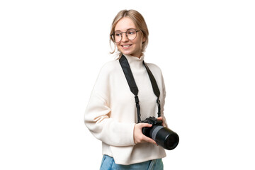 Young photographer English woman over isolated background with arms crossed and happy