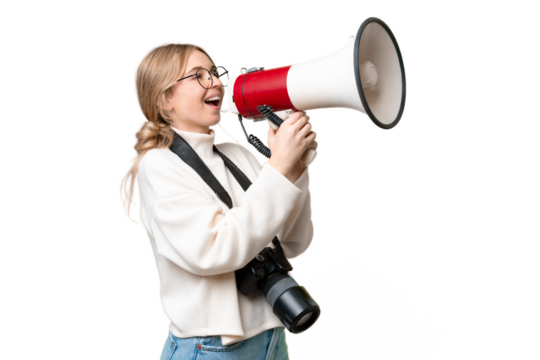 Young photographer English woman over isolated background shouting through a megaphone