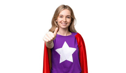 Young English woman over isolated background in superhero costume with thumb up © luismolinero