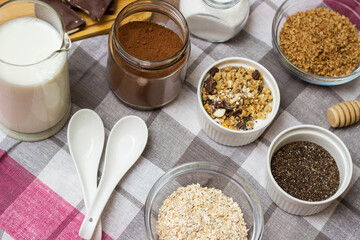 Bowl of chocolate granola with milk and other ingredients