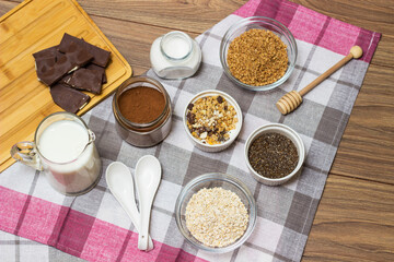 Bowl of chocolate granola with milk and other ingredients