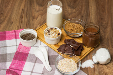 Bowl of chocolate granola with milk and other ingredients