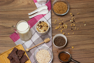 Fototapeta na wymiar Bowl of chocolate granola with milk and other ingredients