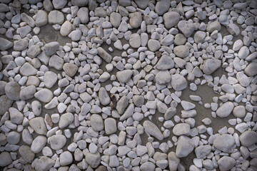 White stone gravel background texture, white sea stones, decorative pebble rock, top view