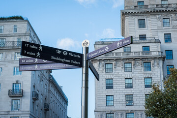 Guide arrows showing different popular directions and walking distances in London city tourist...