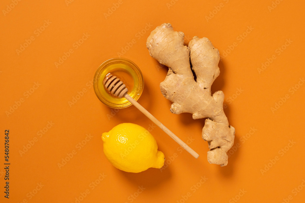 Poster Fresh ginger root lemon honey orange background. Alternative medicine vegetarianism