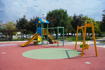 Children playground, swing in the park for children in public park. small empty colorful playground in the city