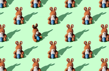 Pattern of soft toy bunny on blue pastel background