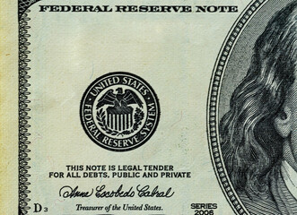 Symbol of the US Federal Reserve System on the old US 100 dollar bill. Fed emblem close-up on american currency.