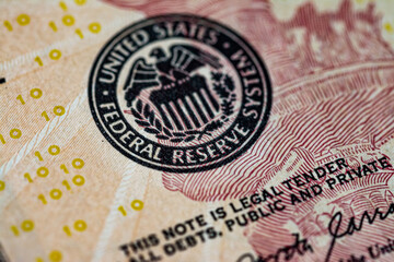 Symbol of the US Federal Reserve System on the US 10 dollar bill. Fed emblem close-up on american currency.