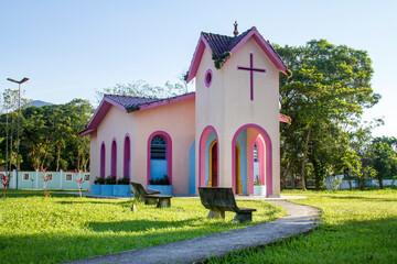 Pink church at dawn, little church with path and benches with sunrise in Sao Sebastião in Sao Paulo Brazil