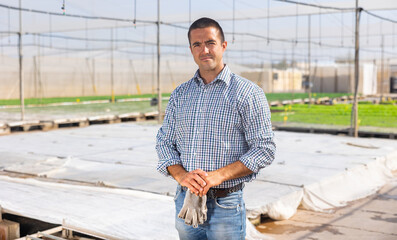 Portrait of confident man horticulturist standing in hothouse