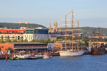 ROUEN, NORMANDY, FRANCE: Armada 2019 gathering of tall ships on the Seine river, crowds of visitors walk on the dock and visit the ships - obrazy, fototapety, plakaty