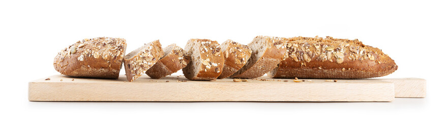 Cereal bread, baguette with assorted seeds cut into slices on wooden cutting board, white background.