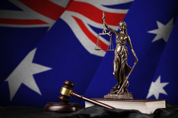Australia flag with statue of lady justice, constitution and judge hammer on black drapery. Concept...