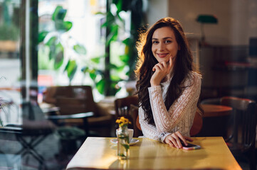 Portrait of beautiful young woman posing in a cafe