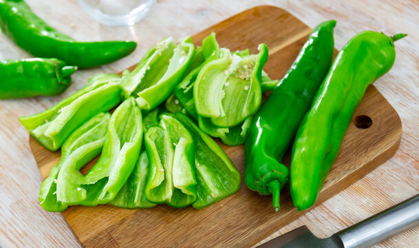 Green Capsicum Chopped On Cutting Board. Sliced Fresh Vegetables As Food Ingredient.