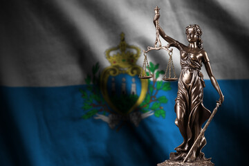 San Marino flag with statue of lady justice and judicial scales in dark room. Concept of judgement...