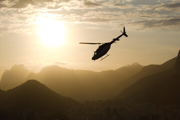 Helicopter at sunset with the mountains of Rio de Janeiro in the background
