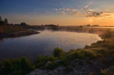 Beautiful morning foggy landscape. Sunrise over the river in Ponidzie in Poland.