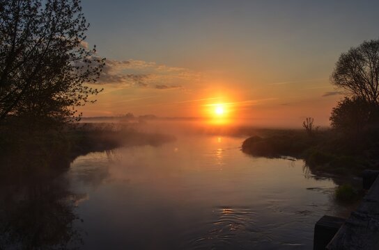 Beautiful morning foggy landscape. Sunrise over the river in Ponidzie in Poland.