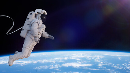 astronaut with safety cable in orbit of planet Earth © dottedyeti