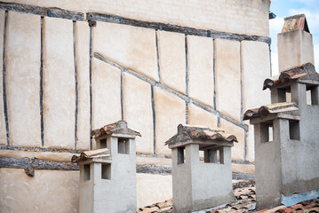 several old chimneys next to old facade