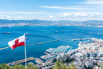gibraltar flag next to harbor views