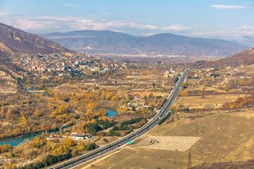 highway with cars among mountainous terrain