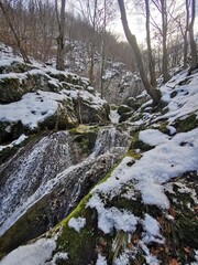 Clear and fresh water with ice and snow in mountain creek