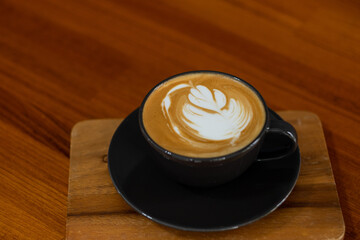 hot latte art coffee on wood table, relax time