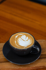 hot latte art coffee on wood table, relax time