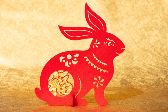 Chinese New Year of Rabbit mascot paper cut on golden background the Chinese means fortune no logo no trademark