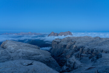 blue hour over dolomites with sea of fog