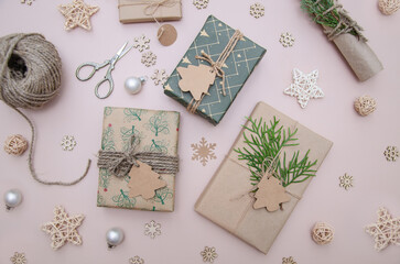 Fototapeta na wymiar Set for gift wrapping. Eco style: natural rough paper, ball of jute, spruce twigs and retro scissors.