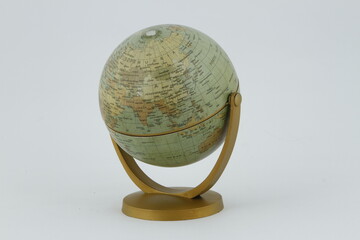 Vintage style miniature wooden globe against a white background