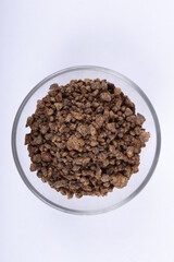 Bowl of unprocessed muscovado rocks against a white background
