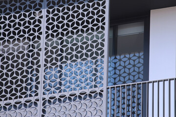 Close up of a balcony patterned shade screen on an apartment