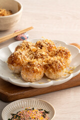 Homemade rice ball in takoyaki style on wooden table background.