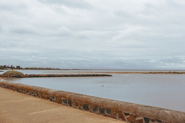 altona beach and sea with overcast skies and city of melbourne in the background