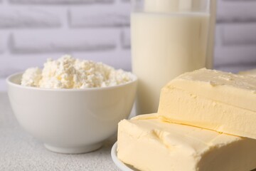 Tasty homemade butter and dairy products on white textured table, closeup