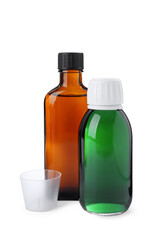 Bottles of syrups with measuring cup on white background. Cough and cold medicine