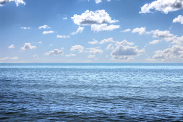 Obraz premium Beautiful view of seascape and blue sky with white clouds on sunny day