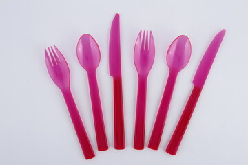 Pink plastic utensils: spoons, forks and knives