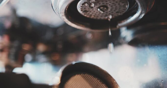 Barista doing preparations for making coffee with espresso machine, close up shot, slow motion