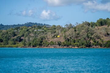 tourist boats and tour boats in the whitsundays queensland, australia. travellers on the great barrier reef, over coral and fish. tourism yachts of young people partying on the water