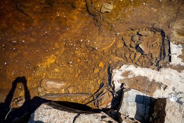 red rocks in a stream iof tannin water